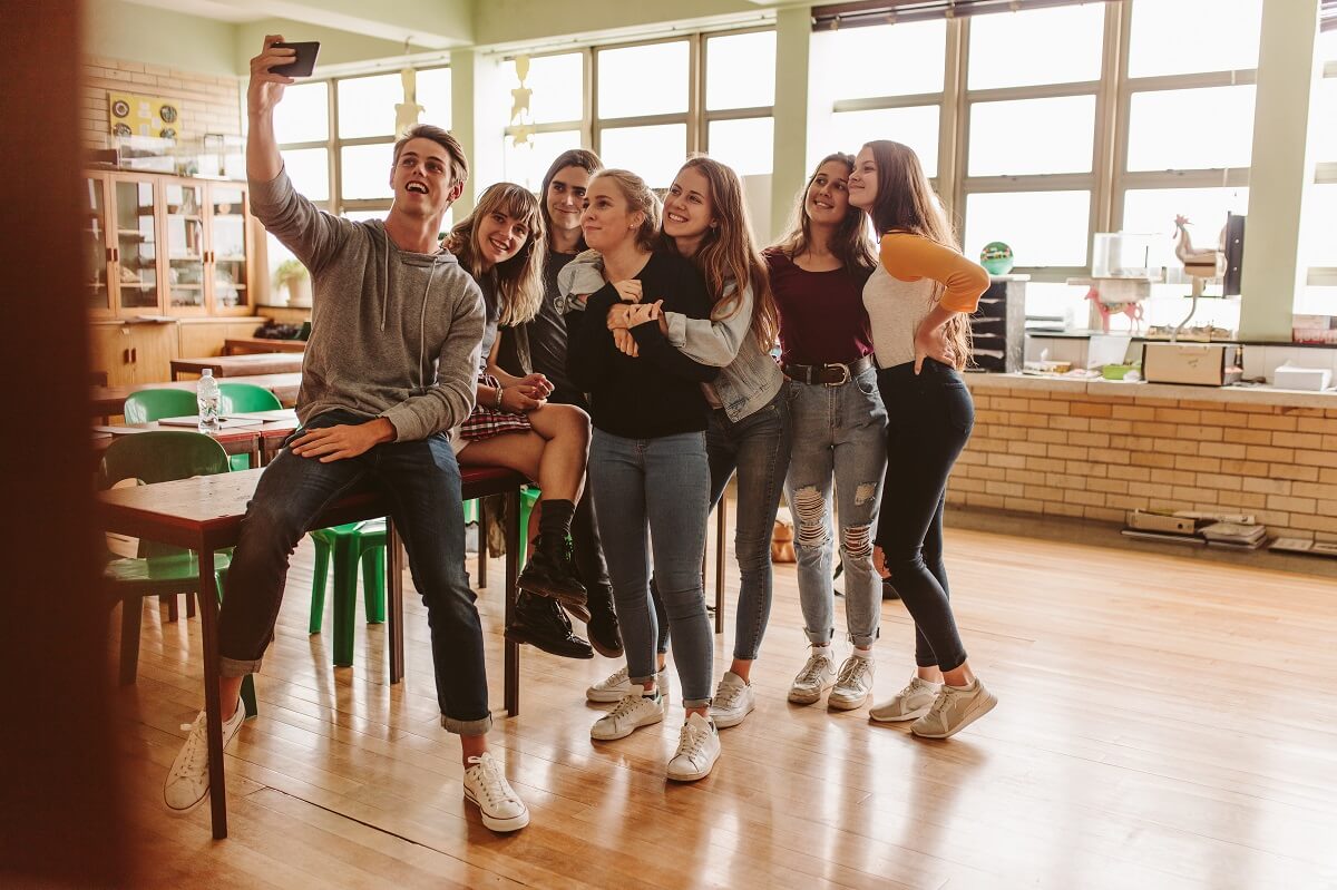 uczniowie w klasie robiący sobie selfie